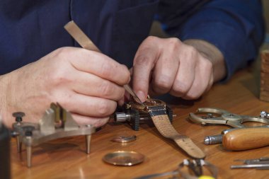 A man repairing a watch clipart