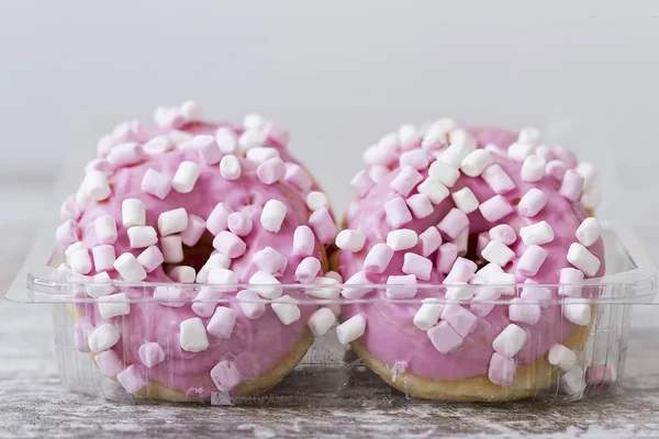 PInk chocolate donuts with a marshmallow topping