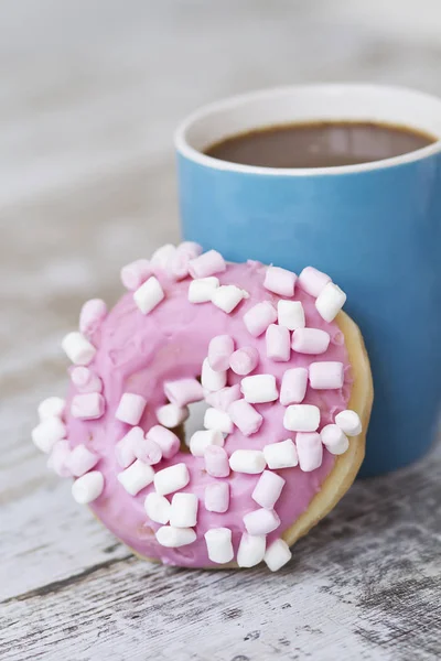 Pink chocolate donuts with a marshmallow topping