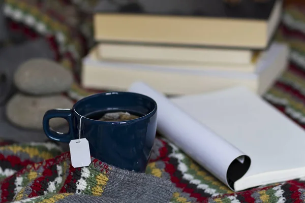 A warm scene of a cup of tea and books