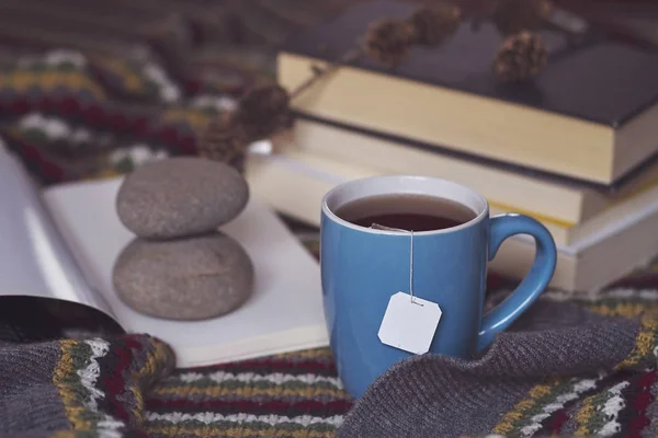 A warm scene of a cup of tea and books