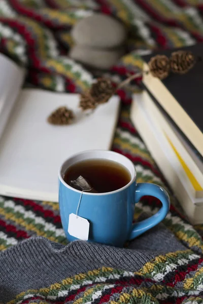 A warm scene of a cup of tea and books