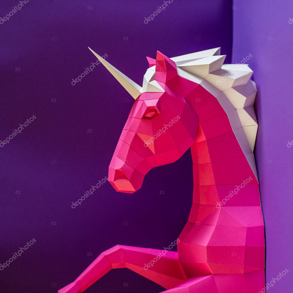Head of a unicorn of paper on a pink and blue background. Geometry, pastel colors.