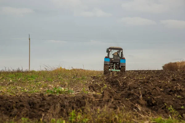 Agricultural work with tractors, plowing the land.