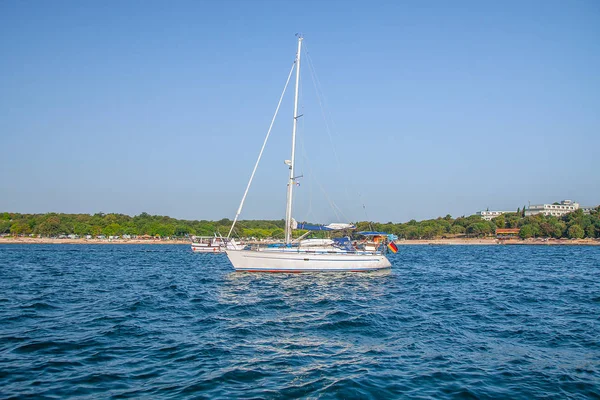 The yacht is sailing in the crystal clear waters off the coast of Croatia, Europe.