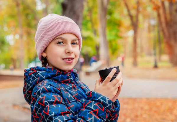 Happy girl dziecko w parku odpoczynku z gorącą herbatą na spacer, jesień przytulny nastrój. — Zdjęcie stockowe