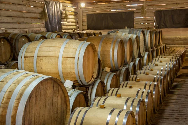 Wine production. Wooden wine barrels are found at the winery. They are ready to pour or are already filled.