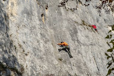 büyük bir kaya duvarı iki dağcı