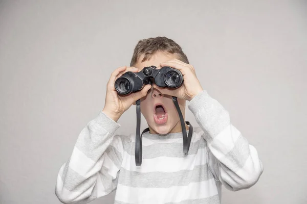 Boy Looks Astonished Black Binoculars Future White Background — Stock Photo, Image