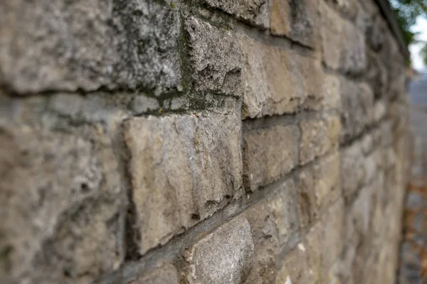 old stone wall at a street with text space