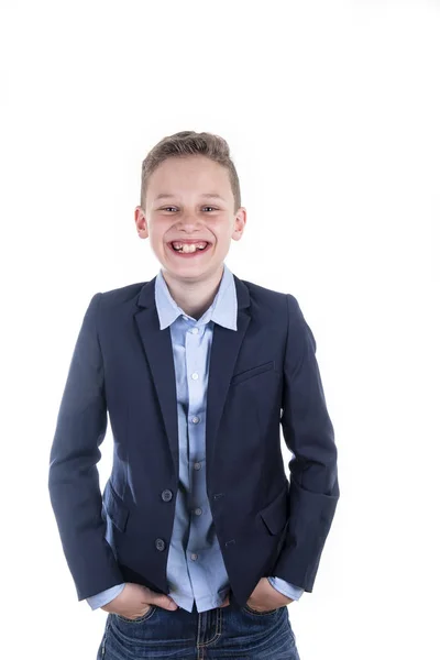 Boy in blue shirt and blue jacket laughs frontally into the camera — Stock Photo, Image