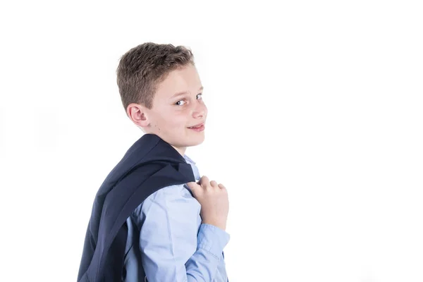 Boy in blue shirt and blue jacket holds his jacket loosely over his shoulder — Stock Photo, Image