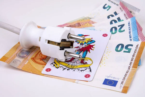 Electric plug with Joker playing card and Euro banknotes