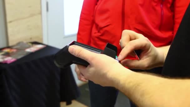 Man Wearing Red Jacket Paying His Credit Card Debit Card — Stock Video