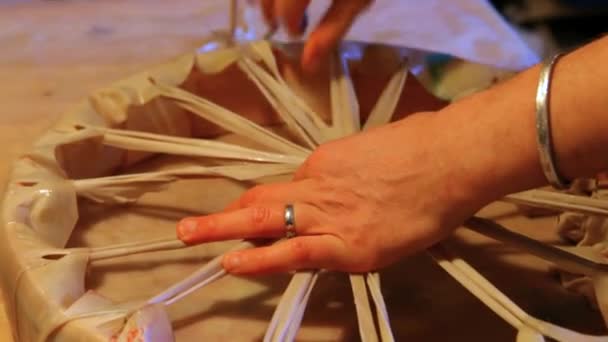 Hands of an artisan making sacred drum. — Stock Video