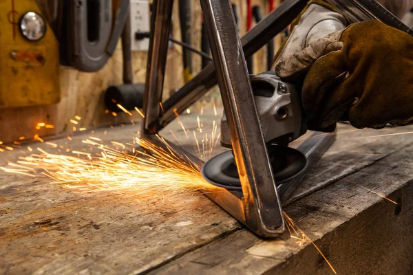 Sparks fly from blacksmith disc grinder — Stock Photo, Image