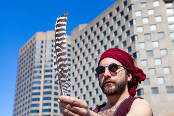 El hombre espiritual sostiene la pluma en la ciudad — Foto de Stock