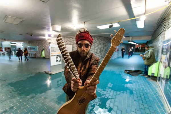 Shaman holds guitar in underground — Stock Photo, Image