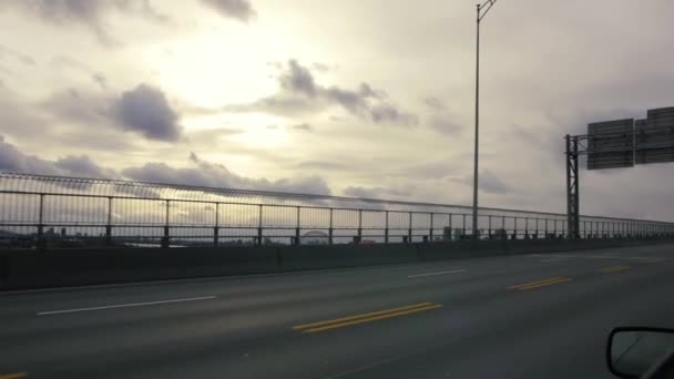 Traveling shot driving over bridge, cityscape on horizon — Stock Video