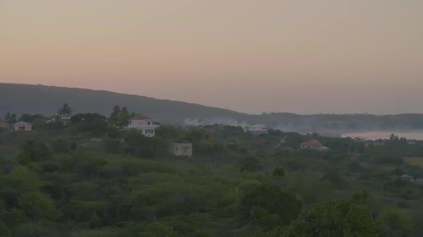 Casas de pueblo cerca de la fábrica emitiendo humo — Vídeo de stock