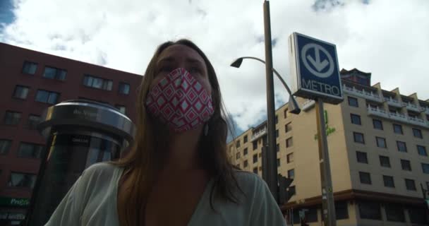 Femme avec masque debout devant la station — Video