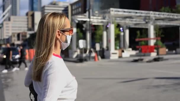 Junge Frau mit Maske und Schutzbrille beim Gehen — Stockvideo
