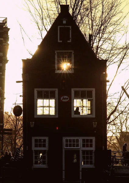 Architecture of Amsterdam. Building on sunset light background. Sunset in the city.