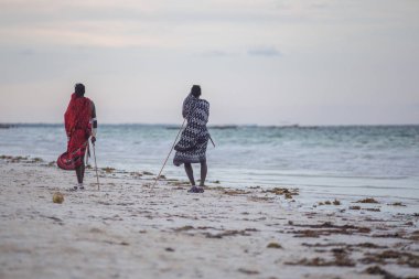 2018.02.21, Kiwengwa, Tanzanya. Tanzanya seyahat. Okyanus arka plan üzerinde duran iki etnik adam. İnsanlar sahilde.