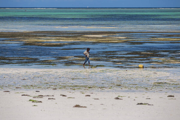 2018.02.21, Kiwengwa, Tanzania. Travel around Tanzania. A little boy on the coast on background of blue sky and ocean.