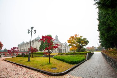 Eski Saat Kulesi eski binanın çatısında red vardır yaprakları, turuncu ve mavi gökyüzü. Sonbahar Yamagata, Japonya