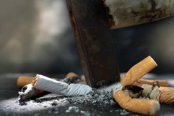 The World No Tobacco Day falls on May 31 of every year.Smoke cigarettes were smashed, destroyed by an iron hammer.Smoking stop concept Eliminate smoking.vintage tone.