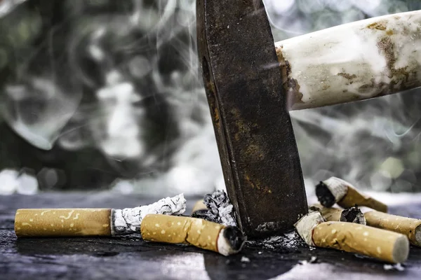 The World No Tobacco Day falls on May 31 of every year.Smoke cigarettes were smashed, destroyed by an iron hammer.Smoking stop concept Eliminate smoking.vintage tone.