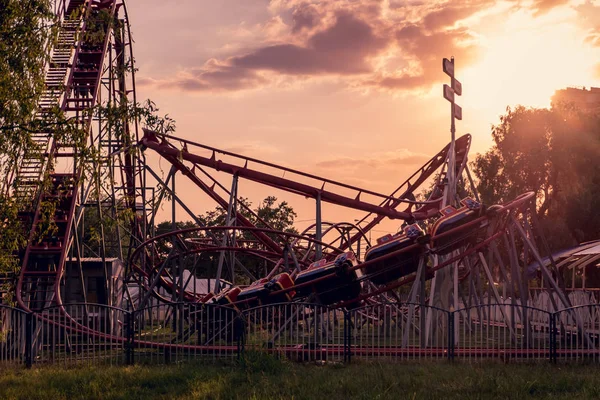 Roller coaster in the evening at sunset in the city park