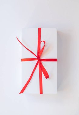 Beyaz hediye kutu kırmızı kurdele ile bağlanmış. Tatil hediye. Üstten görünüm