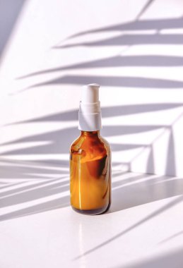 Kozmetik bir ürünün yaratıcı minimalistik çekimi. Spa konsepti. Doğal organik kozmetik ambalajlama palmiye yapraklarıyla taklit edilir..