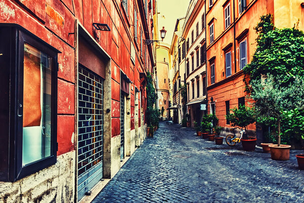 Italian Street with facade garages, flowerpots and bright buildings