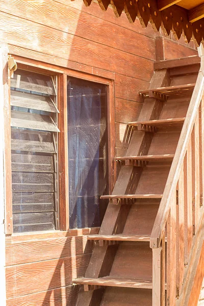 Wooden steps up in eco house outside in a village