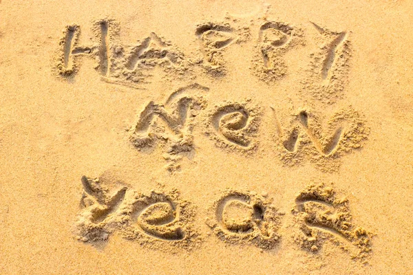 Handwriting Happy New Year on the sand. — Stock Photo, Image