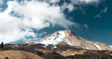 Whispy beyaz bulutların üzerinde kar dağ tepe (gerçek zamanlı şapkalı)
