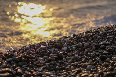 Batan güneşin Beach'te taş