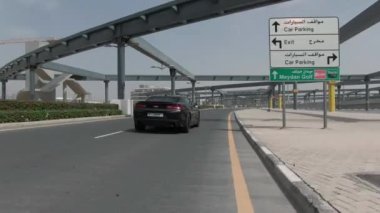 Kamera, Meydan, Dubai 'deki kavşağın altındaki siyah spor arabayı takip ediyor. İnsansız hava aracı