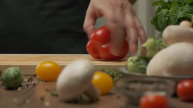 Profesyonel şef kırmızı ve yeşil dolmalık biber hazırlar. Ağır çekimde kapat