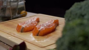 Profesyonel şef kırmızı balık bifteğini kızartma için hazırlar. Ağır çekimde kapat.