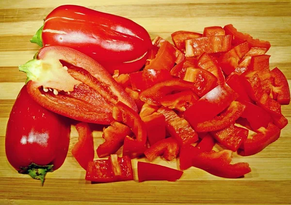 Ripe red bell pepper Bulgarian cut on wooden board