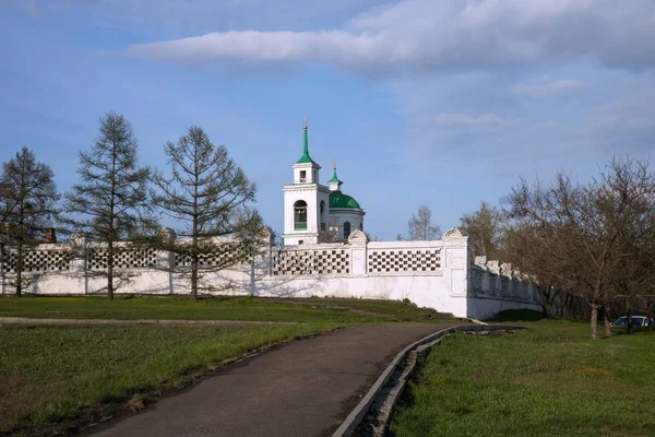 Holy Trinity Cathedral (1836) and the Fence of the Trinity cemetery (1842) of the Krasnoyarsk city, in the spring afternoon. Krasnoyarsk Region. Russia.