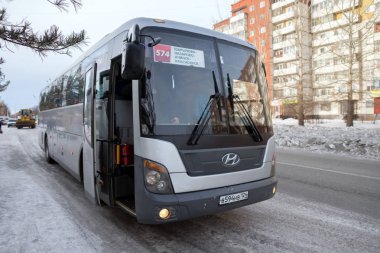 SHARYPOVO / Krasnoyarsk Territory / RF - March 7, 2018:  A commuter bus of suburban route Sharypovo-Krasnoyarsk costs around the bus station awaiting passengers.