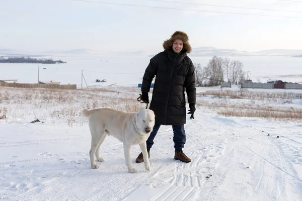 Young Man Stands Big Dog Rural Road Frozen Lake Winter — Stock Photo, Image