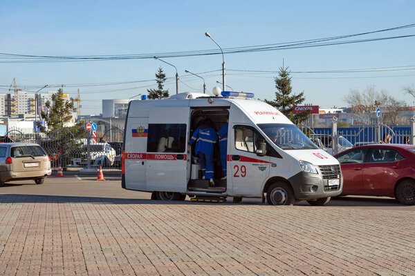 Krasnoyarsk, Krasnoyarsk Region / RF - October 30, 2018: A doctor will climb into a white ambulance that stands in the Northern district of Krasnoyarsk, near the parking lot in the fall