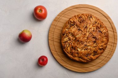 Beyaz arka planda Cornish elmalı turtası üst görünümü. Üç elmanın yanında. Metnin için boşluk kopyala