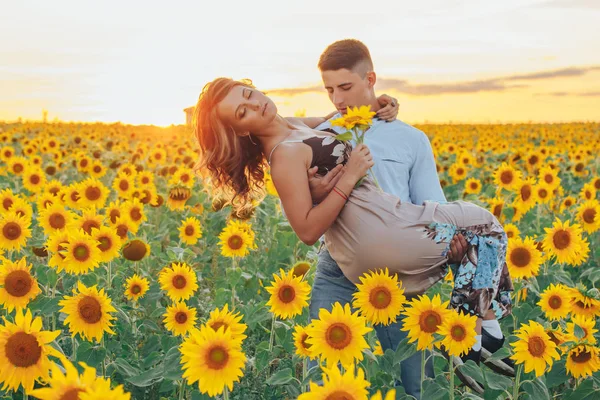 loving couple in field of sunflowers